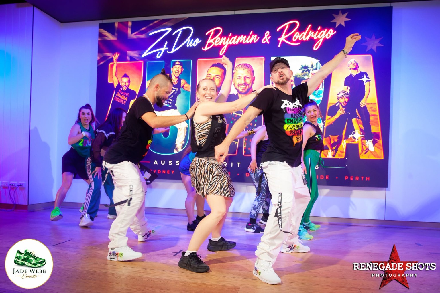 Benjamin and Rodrigo dancing with Jade and other instructors on stage at the Sydney masterclass
